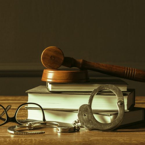 Gavel With Books On Old Wooden Desk