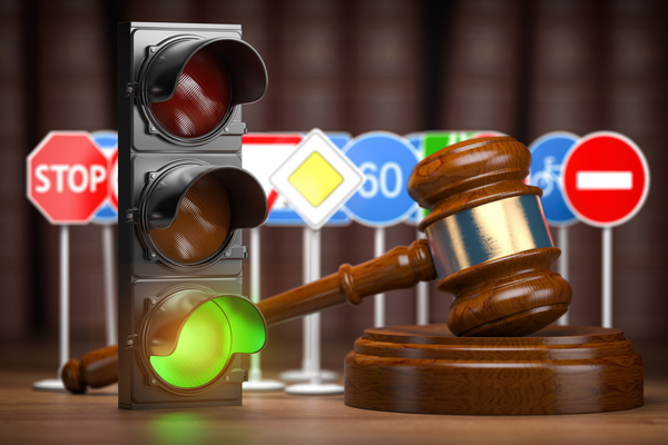 Traffic law concept. Judge gavel with traffic lights and traffic signs. 3d illustration